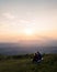 Young couple enjoying the fantastic mountain panorama at sunset