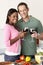 Young Couple Enjoying Glass Of Wine In Kitchen