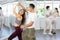 Young couple enjoying impassioned merengue in latin dance class