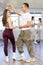 Young couple enjoying impassioned merengue in latin dance class