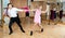 Young couple enjoying practicing jitterbug movements in studio