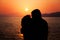 Young Couple Enjoying the Sunset on the Beach. Kiss