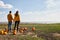 Young couple enjoying sunset in pumpkin patch field