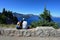 Young couple enjoying view of Crater Lake, Oregon.