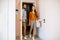 Young couple entering home in the corridor of the modern flat