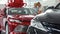 Young couple examining cars for sale at the dealership