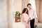 Young couple expecting baby standing together. Romantic moment for a pregnant couple. Planned Parenthood. Pregnancy, maternity,