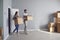 Young couple family with boxes to move in a new house room.