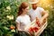 Young couple of farmers working in greenhouse