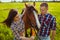 Young couple feeding horse