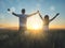 Young couple feeling free in a beautiful natural setting, in what field at sunset