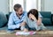 Young Couple Feeling sad and stressed paying bills debts mortgage having financial problems