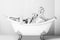 Young couple foreplay lying in tub, intimacy lovers, women