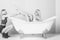 Young couple foreplay lying in tub, intimacy lovers, women