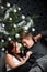 Young couple in front of Christmas tree