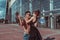 Young couple girl and man dancer happy play have fun laugh, dance glass windows background, summer city, hip hop style