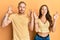 Young couple of girlfriend and boyfriend hugging and standing together relaxed and smiling with eyes closed doing meditation