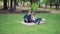 A young couple goes to the park for a picnic. The guy and the girl spread a blanket in nature and sit down to rest