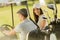 Young couple at golf cart