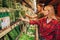 Young couple in grocery store. They stand in front of herbs shelf and pick them together. Serious concentrated people in