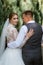 young couple the groom in a plaid suit and the bride in a chic white dress