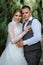 young couple the groom in a plaid suit and the bride in a chic white dress