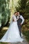 young couple the groom in a plaid suit and the bride in a chic white dress