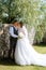 young couple the groom in a plaid suit and the bride in a chic white dress