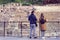 Young couple: a guy and a girl with a backpack visiting the Roman theater of Malaga. Ruin.