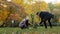 Young couple guy and girl eco-activists plant tree in park engaged in landscaping forest take care of nature environment