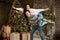 Young couple handsome husband holding his beautiful lovely wife on his shoulders looking happy in room decorated for celebrating