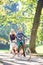 Young couple, handsome man and attractive woman on tandem bike in sunny summer park or forest.