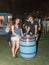 A young couple happily posing near a decorative beer cask at the traditional annual beer festival in Haifa, Israel