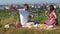 Young couple have a picnic by the cityview