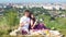 Young couple have a picnic by the cityview