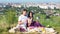 Young couple have a picnic by the cityview