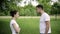 Young couple having fight in summer park, ending man leaves a woman. Slow motion