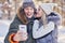 Young couple having fun on snow taking selfie