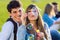 Young couple having fun with soap bubbles in the park