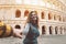 Young couple having fun together in Rome Colosseum - Happy lovers romantic moments during vacations in Italy