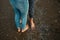 A young couple is having fun and walking on the sea coastline. Legs close up. Romantic date on the beach