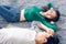 Young Couple Having Relaxing While Lying on Carpet at Their Home, Attractive Asian Couple Love are Relaxed Together on Living Room