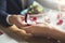 Young couple having romantic dinner in the restaurant holding proposal ring close-up