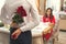 Young couple having romantic dinner in the restaurant surprise roses and proposal ring