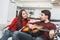 Young couple having romantic evening at home guy playing melody