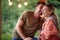 A young couple having romantic moments at the cottage porch in the forest. Vacation, nature, cottage, relationship