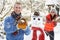 Young Couple Having Snowball Fight In Garden