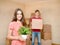 Young couple holding cardboard boxes for moving into a new house