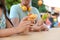 Young couple holding delicious bubble waffles with tomato and arugula at table outdoors