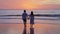 Young couple holding hand together and looking beautiful sunset on the beach, Summer vacation concept